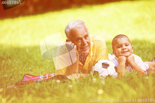 Image of grandfather and child have fun  in park