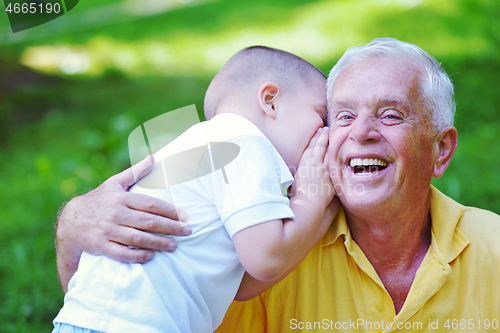 Image of happy grandfather and child in park