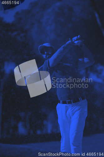 Image of golfer hitting a sand bunker shot