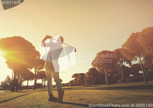 Image of golf player hitting shot with club