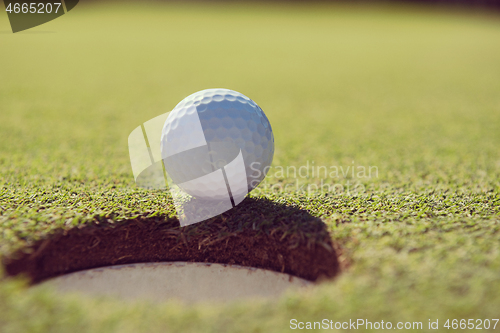 Image of golf ball in the hole