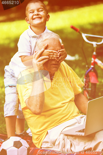 Image of grandfather and child have fun  in park