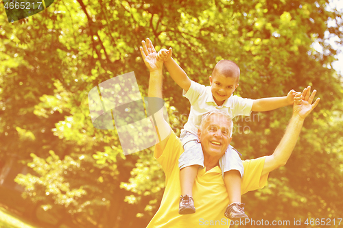 Image of happy grandfather and child in park