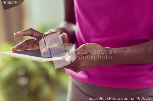 Image of african american woman using tablet