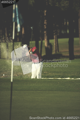 Image of golfer hitting a sand bunker shot