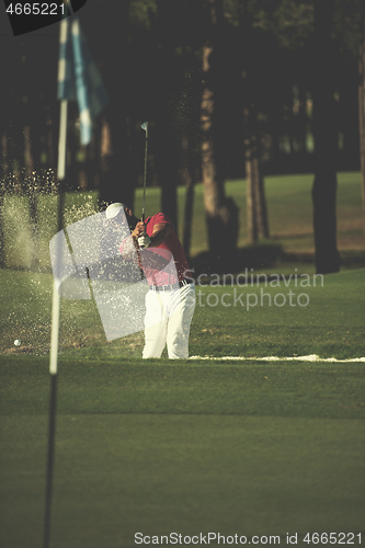 Image of golfer hitting a sand bunker shot