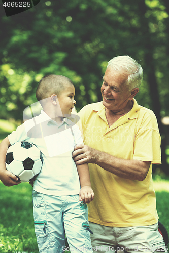 Image of grandfather and child have fun  in park