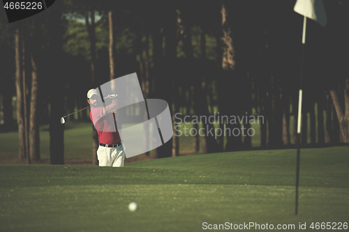 Image of golfer hitting a sand bunker shot