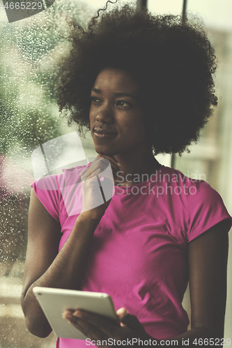 Image of african american woman using tablet