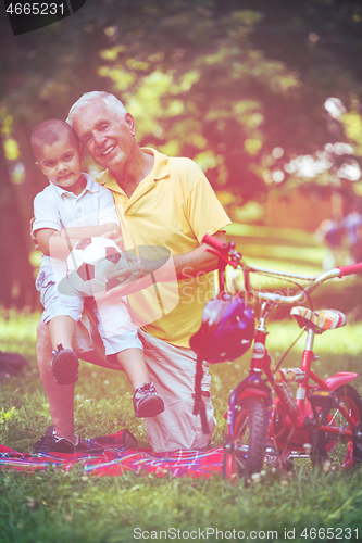 Image of grandfather and child have fun  in park