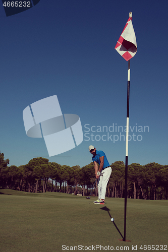 Image of golf player hitting shot at sunny day