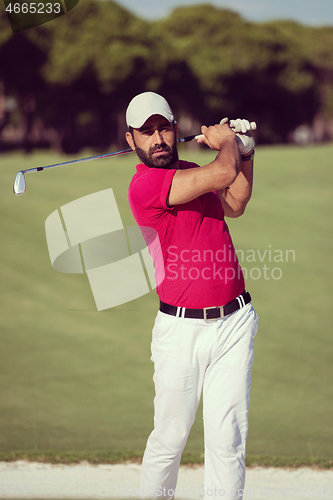 Image of golfer hitting a sand bunker shot