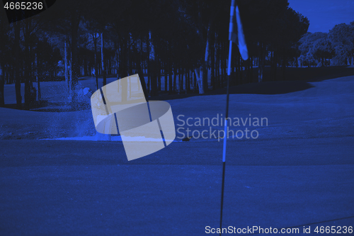 Image of golfer hitting a sand bunker shot