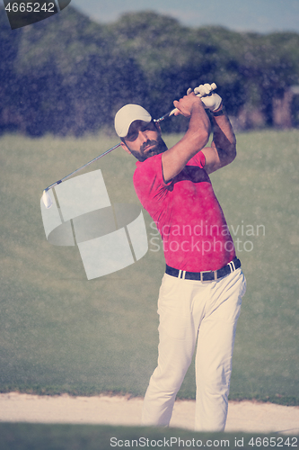 Image of golfer hitting a sand bunker shot