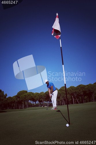 Image of golf player hitting shot at sunny day