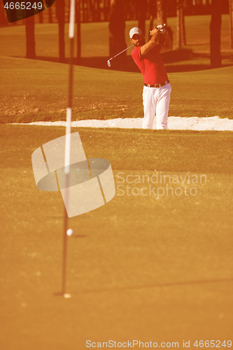 Image of golfer hitting a sand bunker shot