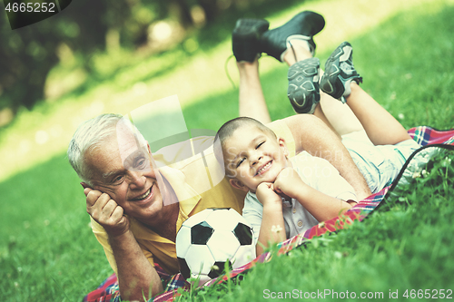 Image of grandfather and child have fun  in park