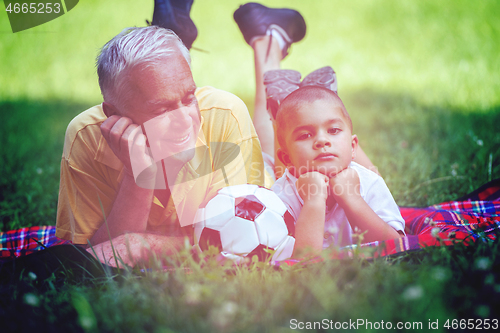 Image of grandfather and child have fun  in park