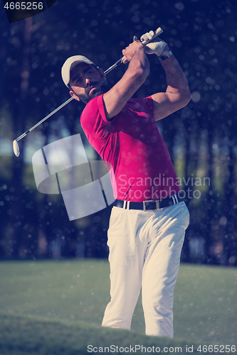 Image of golfer hitting a sand bunker shot