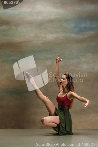 Image of The woman dancing on gray