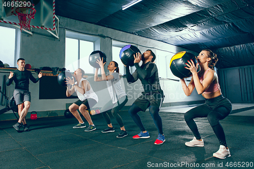 Image of functional fitness workout at the gym with medicine ball