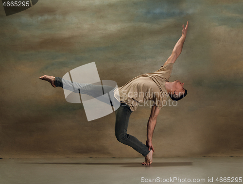 Image of The young man dancing on gray