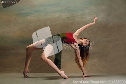 Image of The woman dancing on gray