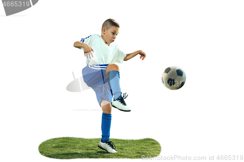 Image of Young boy kicks the soccer ball