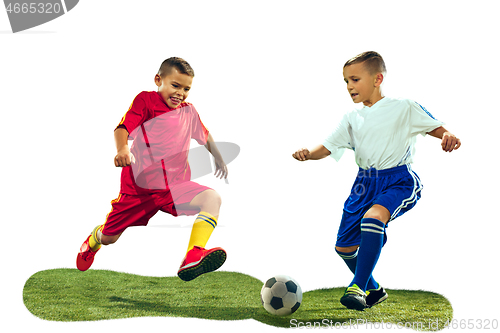 Image of Young boys kicks the soccer ball