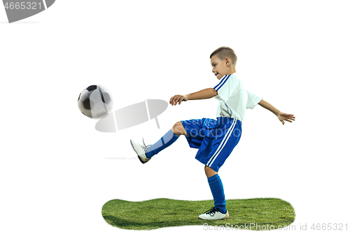 Image of Young boy kicks the soccer ball