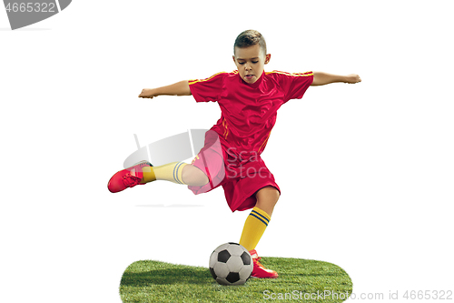 Image of Young boy kicks the soccer ball