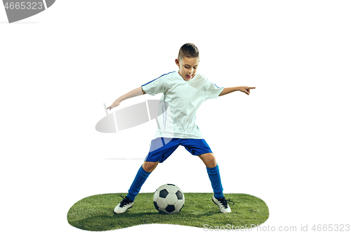 Image of Young boy kicks the soccer ball