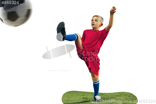 Image of Young boy kicks the soccer ball