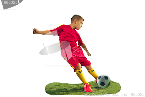 Image of Young boy kicks the soccer ball