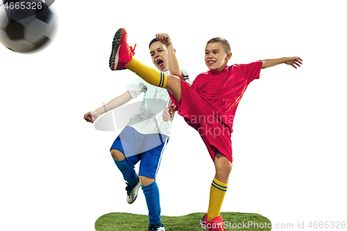 Image of Young boys kicks the soccer ball
