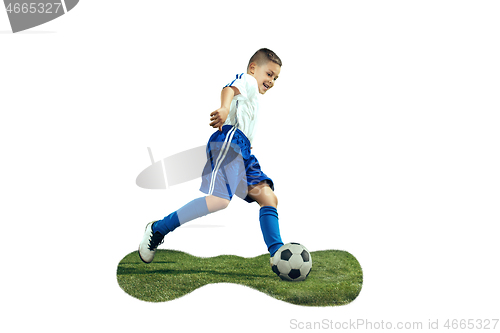 Image of Young boy kicks the soccer ball