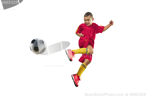 Image of Young boy kicks the soccer ball