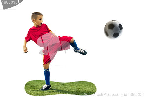 Image of Young boy kicks the soccer ball