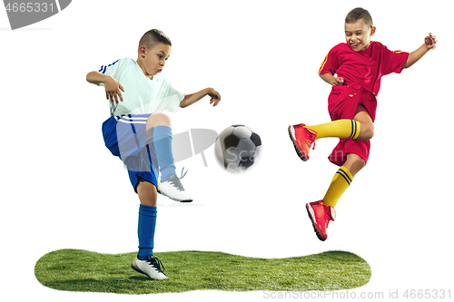 Image of Young boys kicks the soccer ball