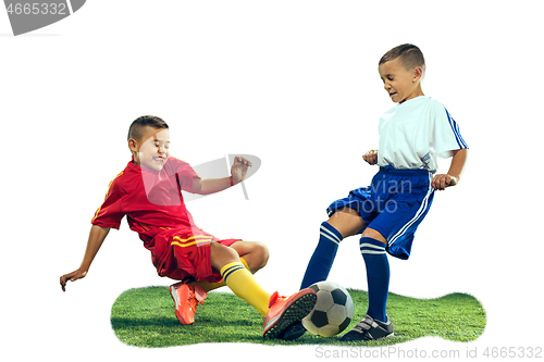 Image of Young boys kicks the soccer ball