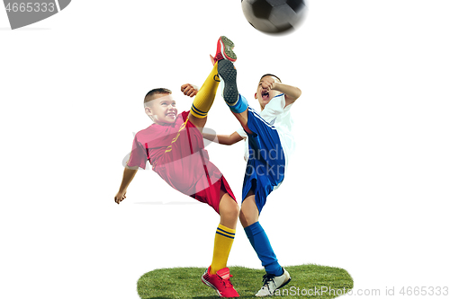 Image of Young boys kicks the soccer ball