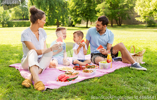 Image of happy family having picnic at summer park