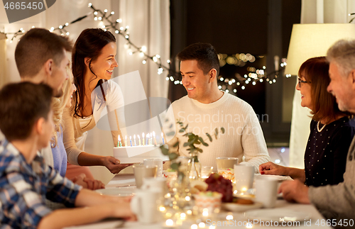 Image of happy family having birthday party at home