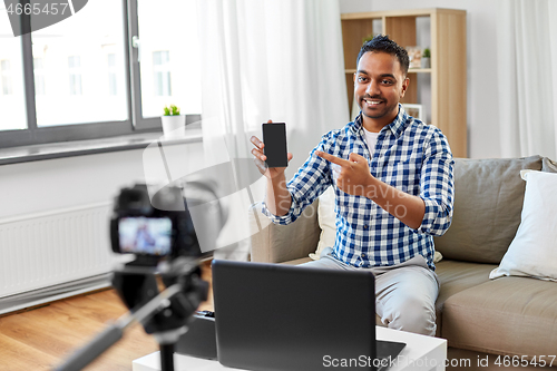 Image of male blogger with smartphone videoblogging