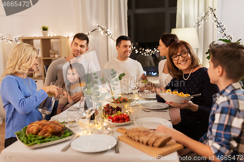 Image of happy family having dinner party at home