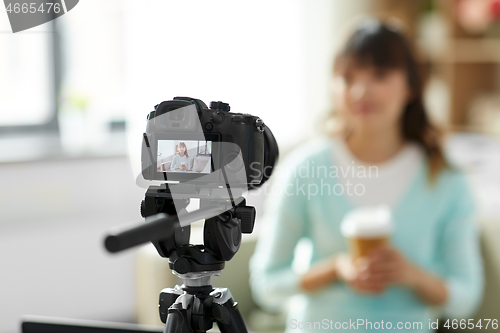 Image of asian female blogger with coffee recording video