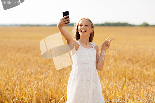 Image of girl taking selfie by smartphone and showing peace