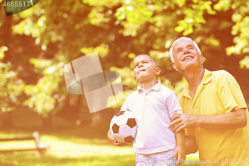 Image of happy grandfather and child in park