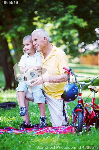 Image of grandfather and child have fun  in park