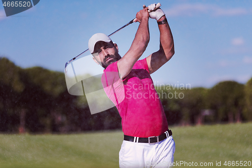 Image of golfer hitting a sand bunker shot